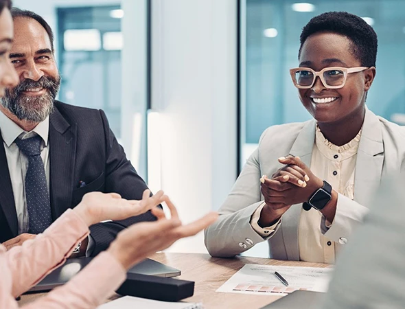 A smiling businesswoman in glasses and a businessman in a suit discussing leadership development strategies in Omaha, Nebraska.