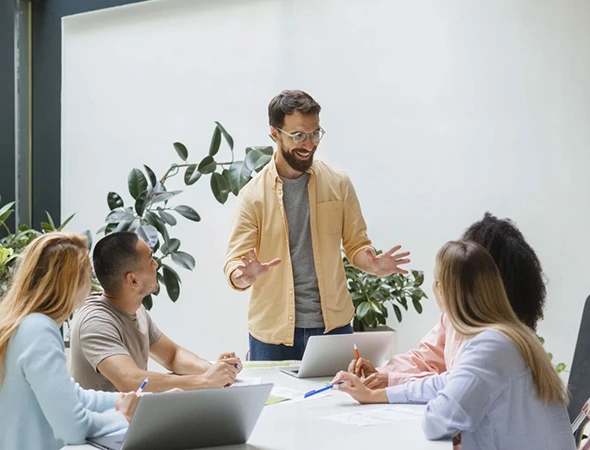 A mentor leading a small group workshop to help clients rebuild focus and achieve personal goals at Red Star Coaching.