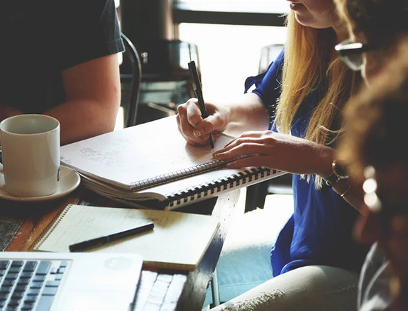 Professionals collaborating during a personalized strengths coaching session in Charles City, IA.