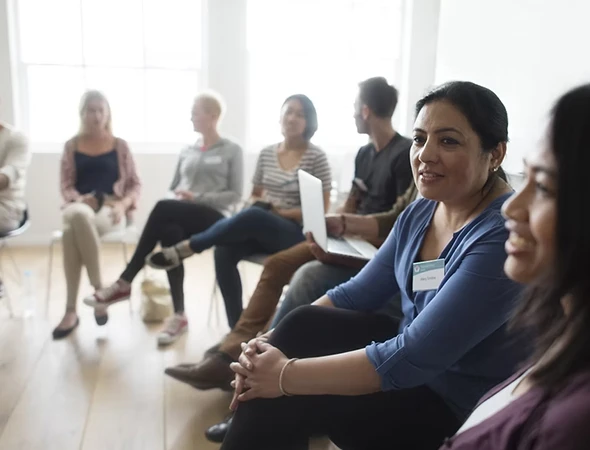 A diverse group of people participating in a strengths identification coaching workshop in Omaha, NE.