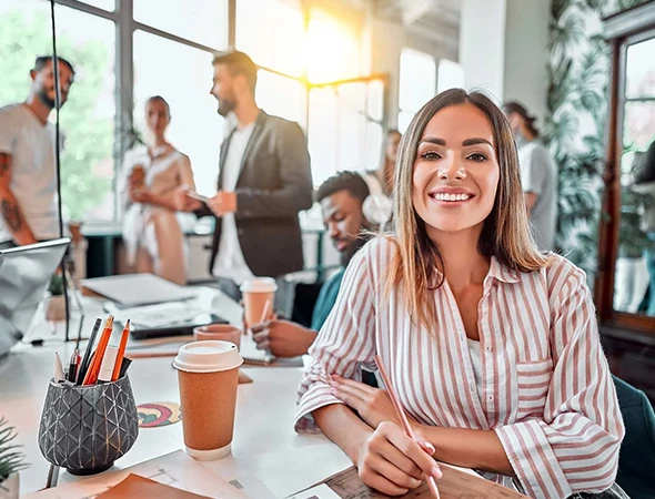 A confident professional woman smiling at her desk during a coaching session in Madison, WI.